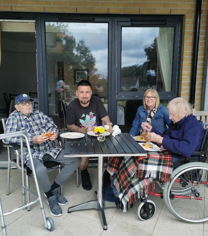 people around a table enjoying a barbecue