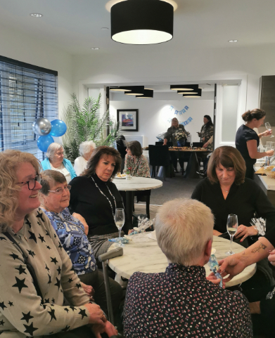 Residents, staff, and guests gathered at Dalgety Bay Care Home’s first birthday celebration, featuring colourful decorations, a ribbon-cutting ceremony, and live bagpipe music.