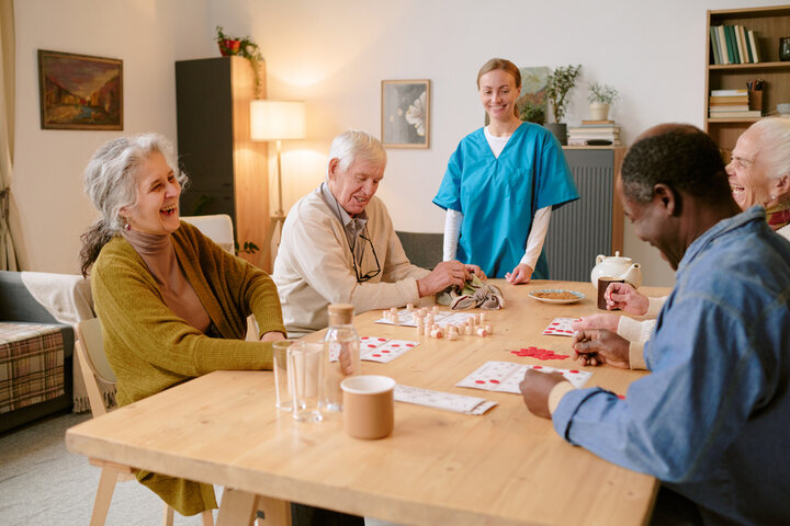 older people enjoying themself playing cards in a care home