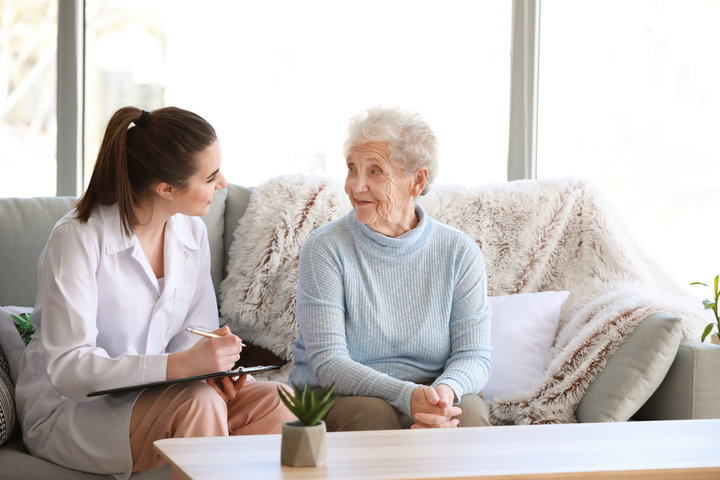 older woman asking questions about residential care to a nurse