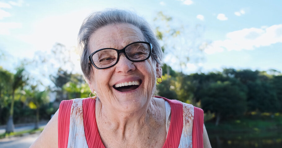older woman smiling in a garden