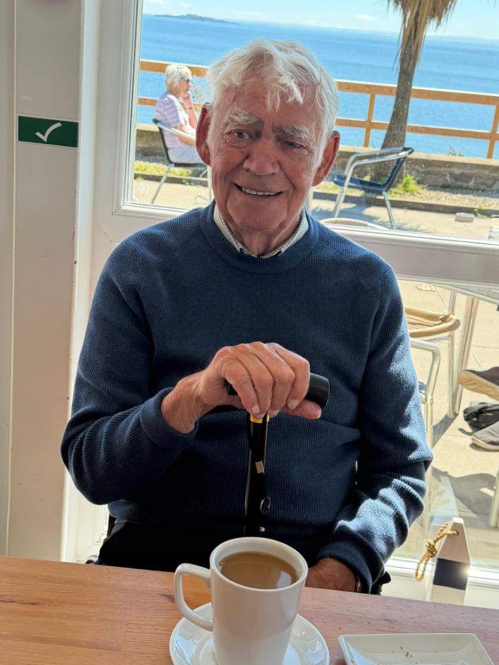 resident smiling with coffee